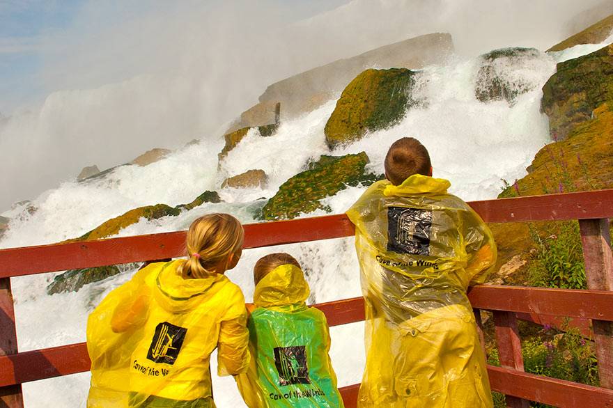 A family stands on the Hurricane Deck at Cave of the Winds in Niagara Falls State Park