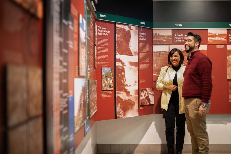 Two guests viewing a display at the Niagara Falls Visitor Center