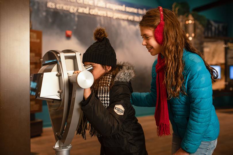Two kids exploring an exhibit at the Niagara Falls Visitor Center