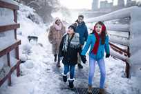 A family exploring Niagara Falls State Park in winter