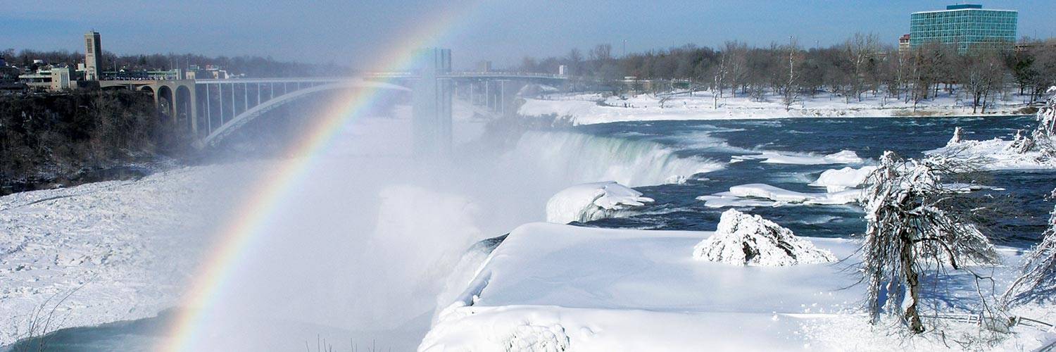View of the American Falls with a rainbow at Niagara Falls State Park in the winter