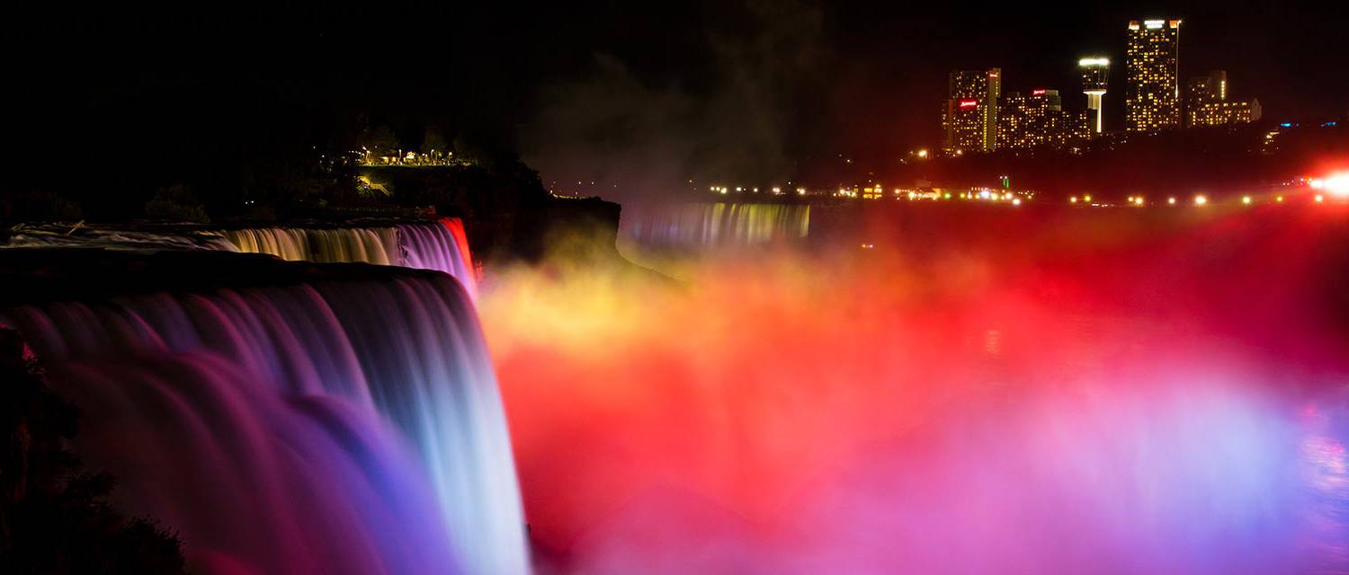 Niagara Falls illuminated at night with lights